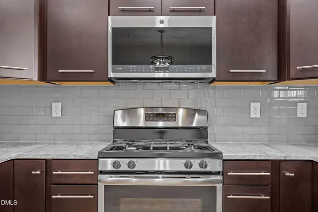 a stove top oven sitting inside of a kitchen