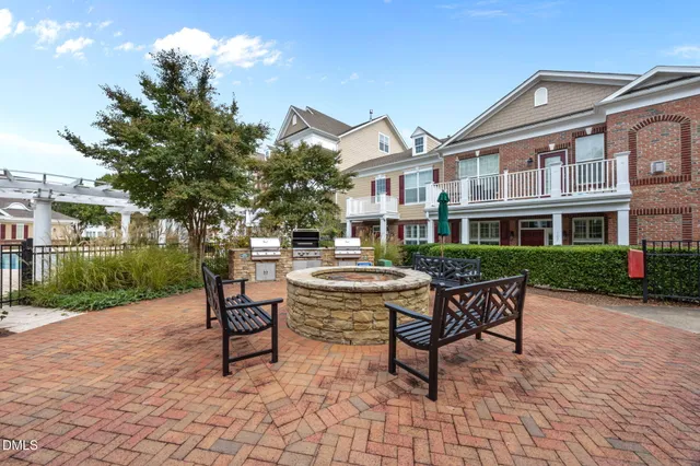 a swimming pool with outdoor seating and a potted plant