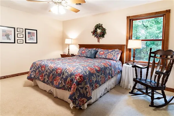 a large bed sitting in a bedroom next to a window