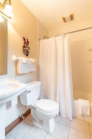 a white toilet sitting next to a bathroom sink