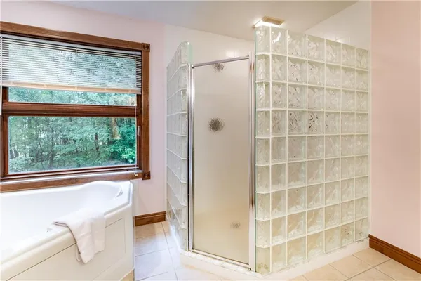 a view of a bathroom with a tub and windows