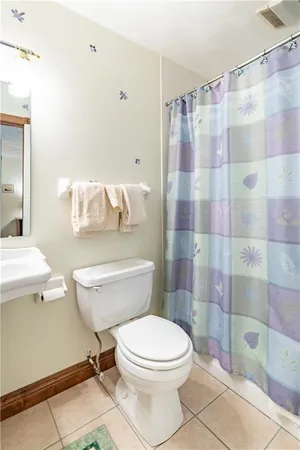 a white toilet sitting next to a bathroom sink