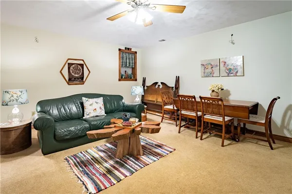a living room with furniture and a dining table