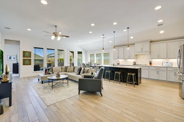 a living room with furniture and kitchen view
