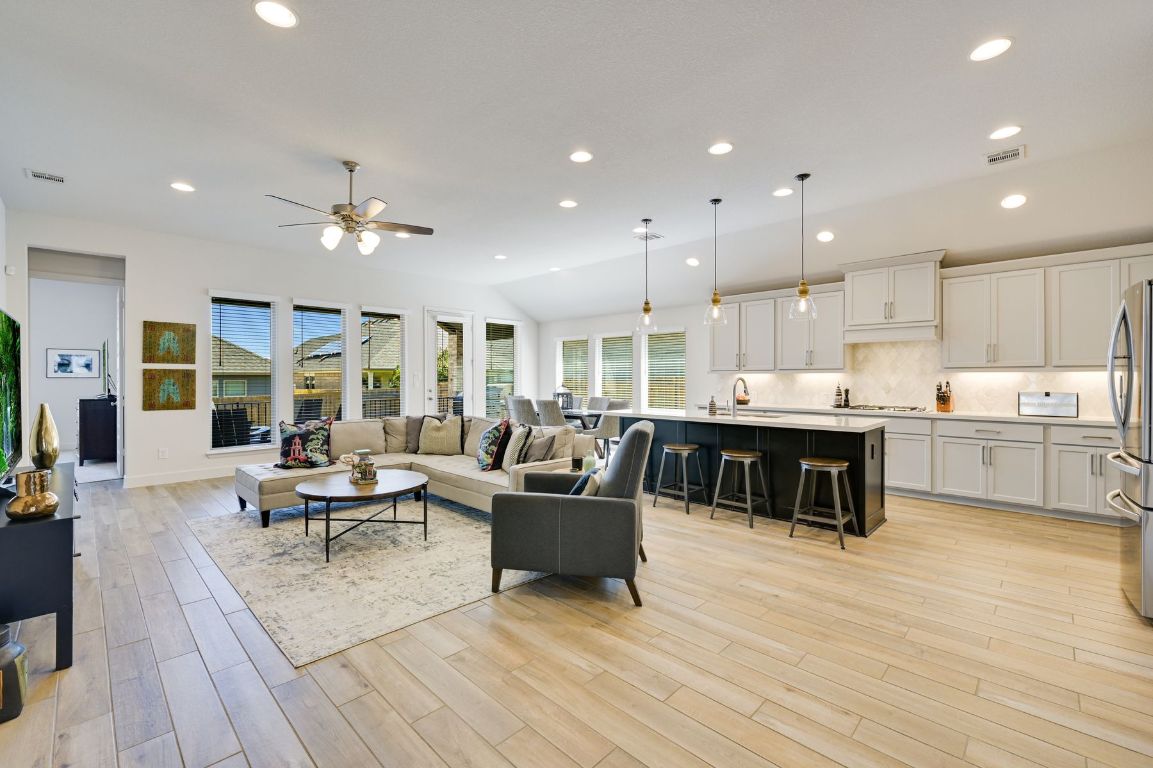 a living room with furniture and kitchen view