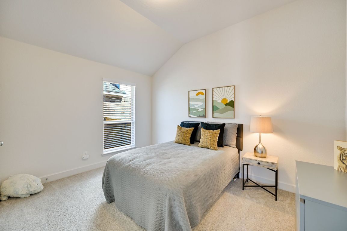 273 Fawn Riv Run Kyle, TX 78640 - Photo 13 of 27 a bedroom with a bed and a window