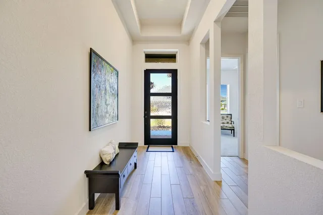 a view of a livingroom with wooden floor and a window