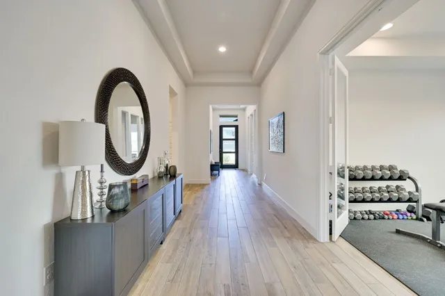 a view of a hallway with entryway wooden floor and front door