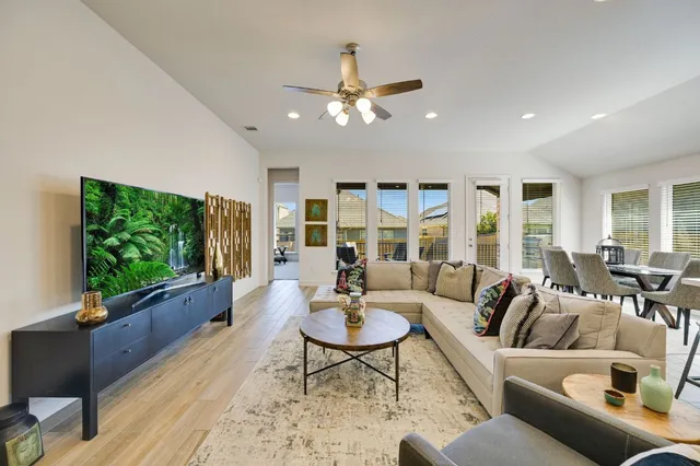 a living room with furniture and a flat screen tv
