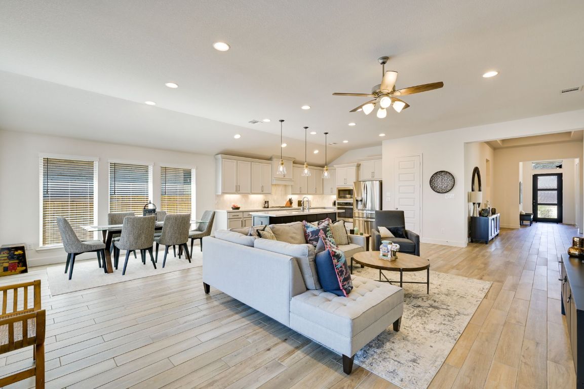273 Fawn Riv Run Kyle, TX 78640 - Photo 5 of 27 a living room with furniture kitchen view and a wooden floor