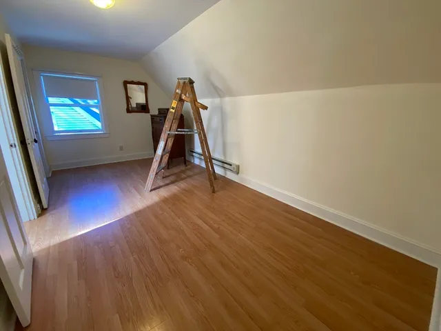 a view of a room with wooden floor and stairs