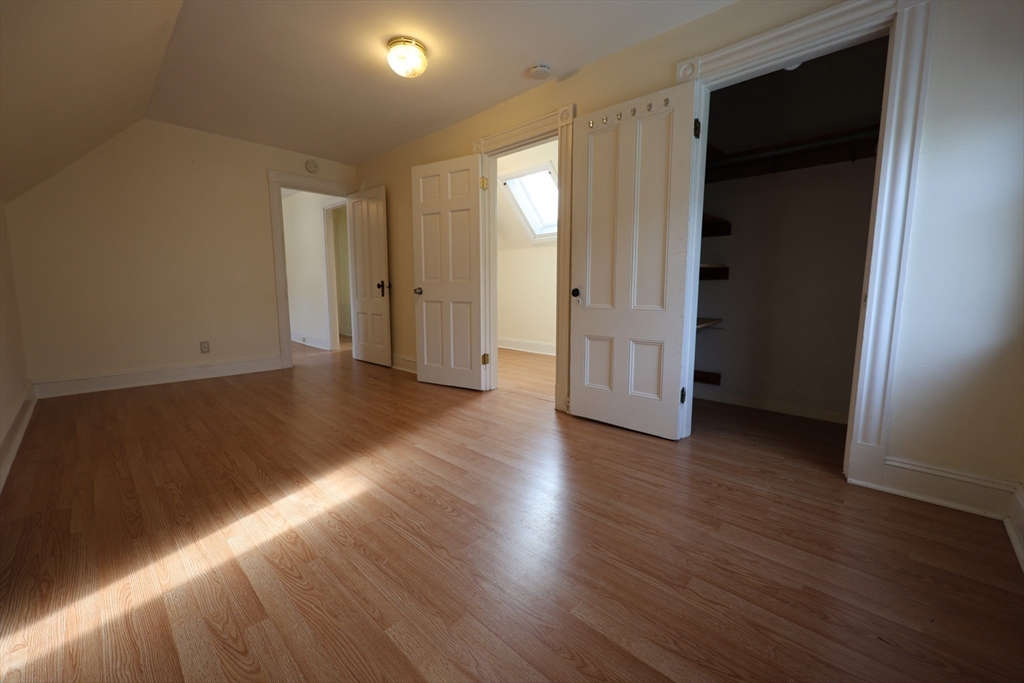 6 Harriet Street, Unit 3 Boston, MA 02135 - Photo 4 of 12 an empty room with wooden floor and closet