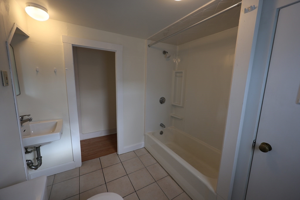 6 Harriet Street, Unit 3 Boston, MA 02135 - Photo 7 of 12 a bathroom with a shower and toilet