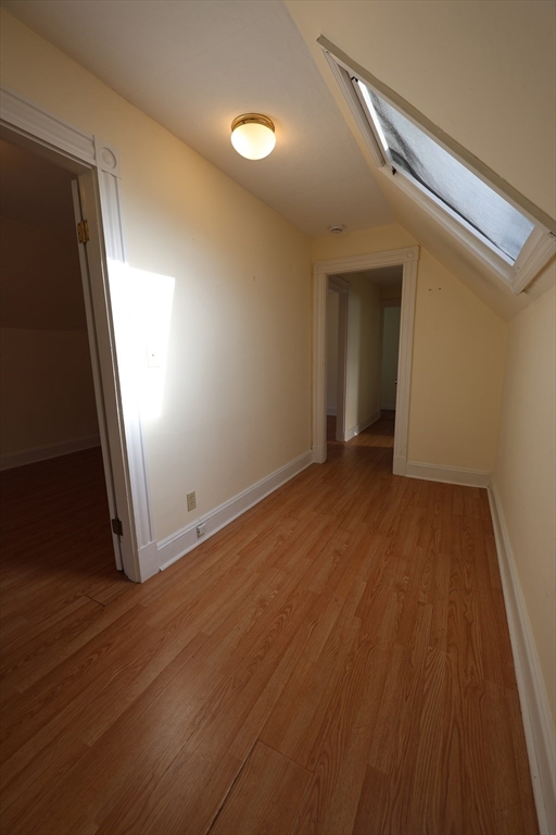 6 Harriet Street, Unit 3 Boston, MA 02135 - Photo 9 of 12 an empty room with wooden floor and entrance