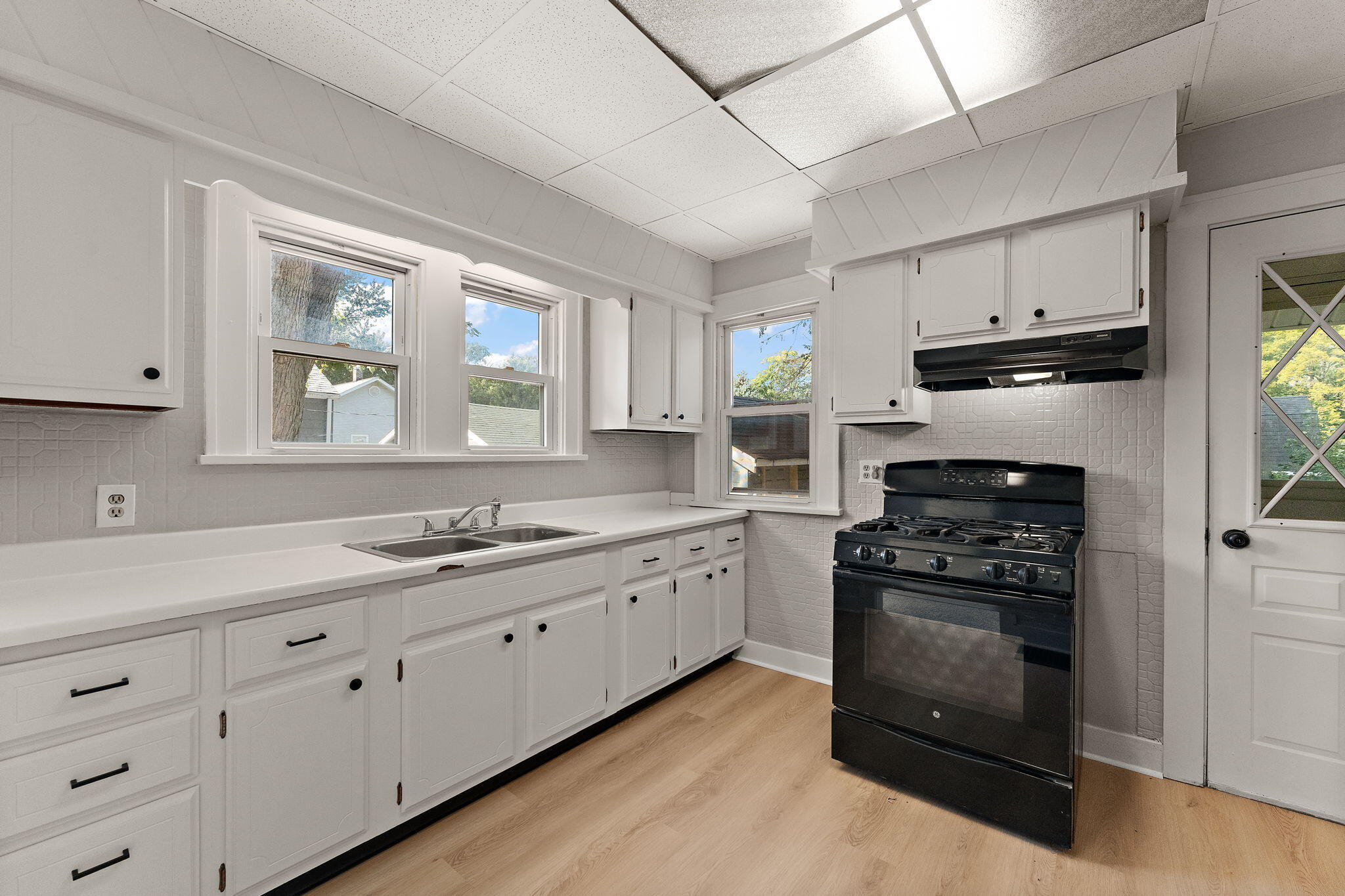 511 North West Street Crown Point, IN 46307 - Photo 14 of 17 a kitchen with granite countertop white cabinets and stainless steel appliances