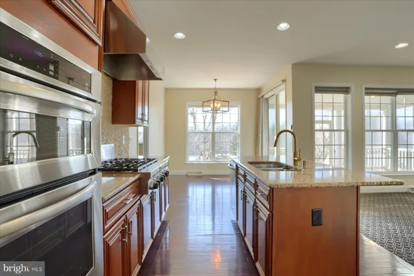 a kitchen with stainless steel appliances granite countertop a stove and a sink