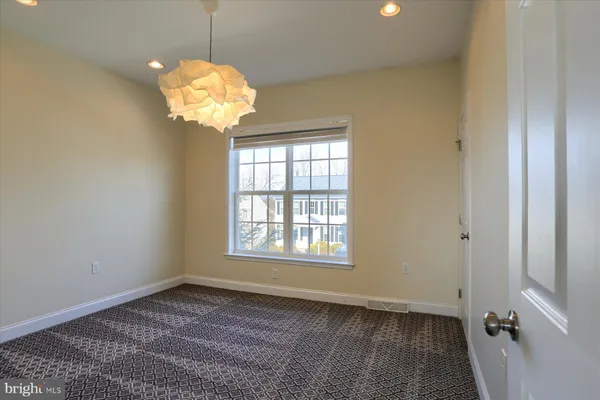 a view of a room with a window and chandelier