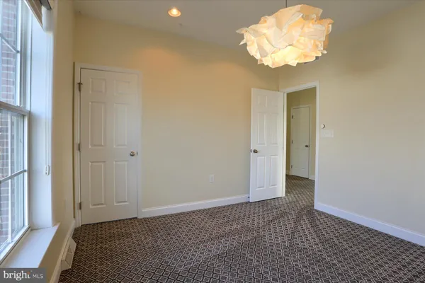 a view of an empty room with a chandelier