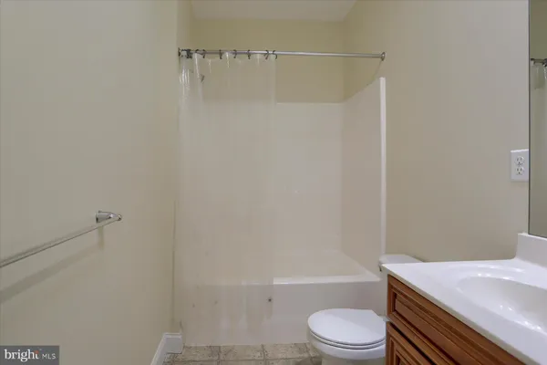 a bathroom with a toilet a sink and a shower