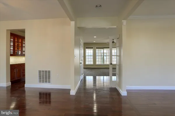 a view of empty room with wooden floor and fireplace