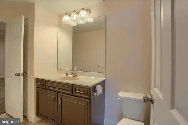 a bathroom with a sink a toilet and a mirror