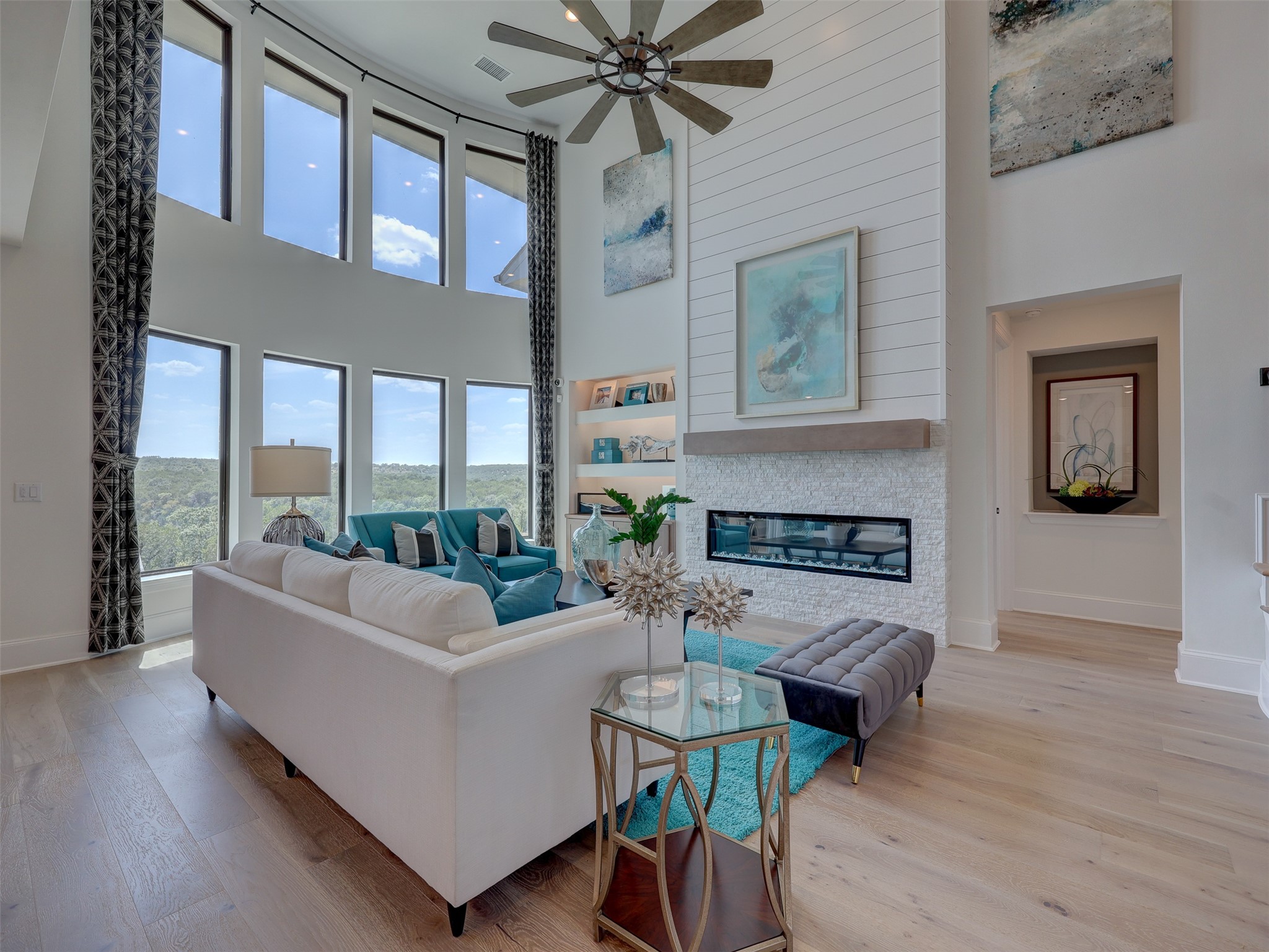 6220 Bower Well Road Austin, TX 78738 - Photo 6 of 28 A striking fireplace and towering windows define this grand living space.