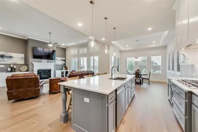 a kitchen with sink stove and cabinets