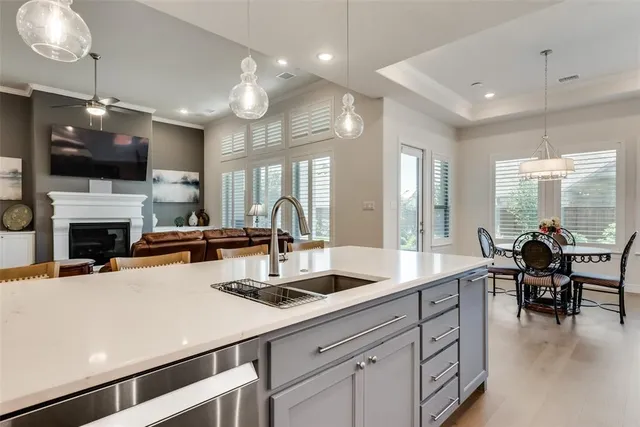 a kitchen with a sink a counter and chairs