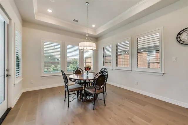 a view of a dining room with furniture windows and wooden floor