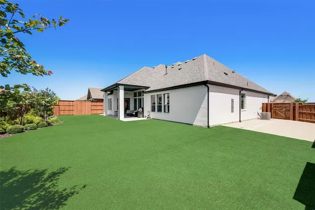 a backyard of a house with lots of green space