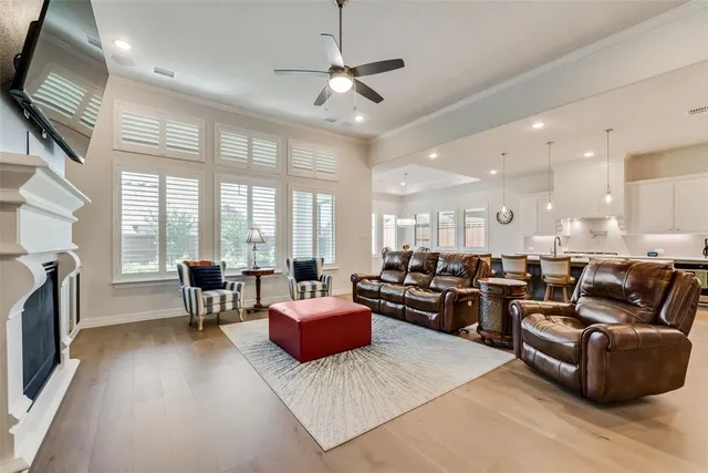 a living room with furniture fireplace and a large window