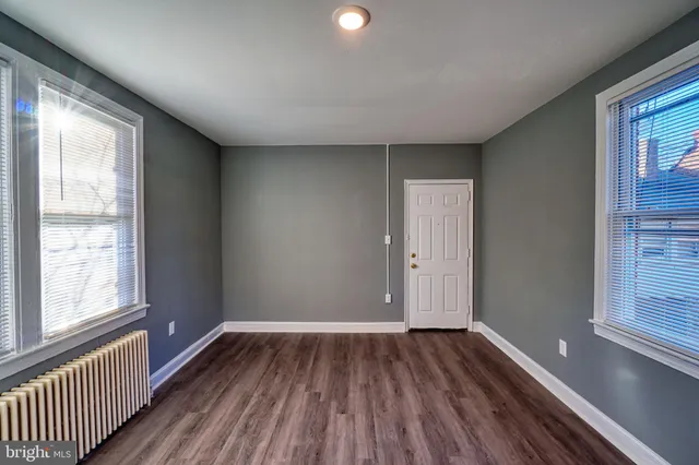 a view of a room with wooden floor and window