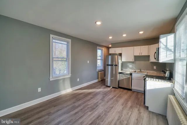 a kitchen with a refrigerator and a stove top oven