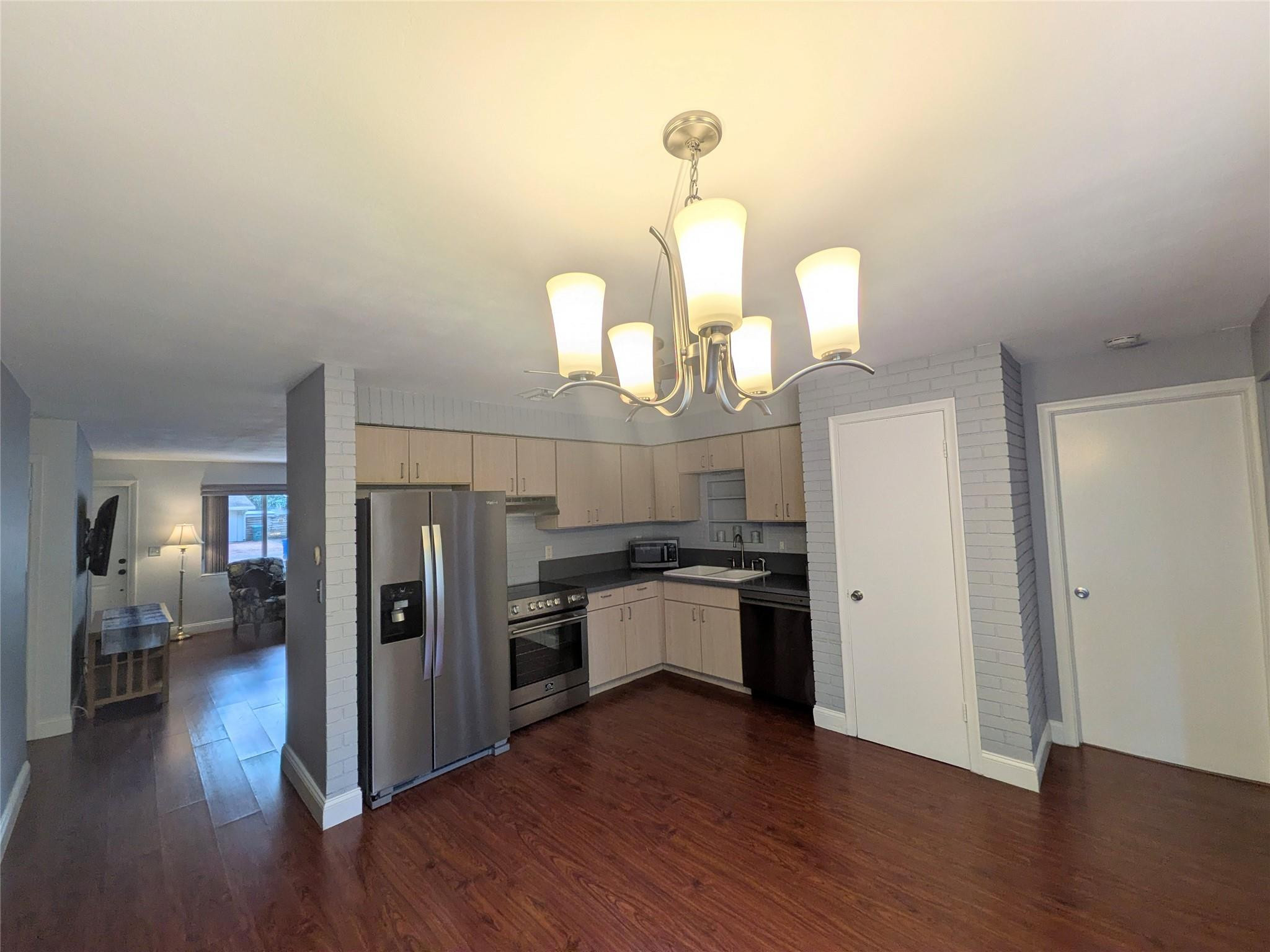 9401 Southwest 53rd Street Cooper City, FL 33328 - Photo 5 of 17 a kitchen with stainless steel appliances a refrigerator and a wooden floor