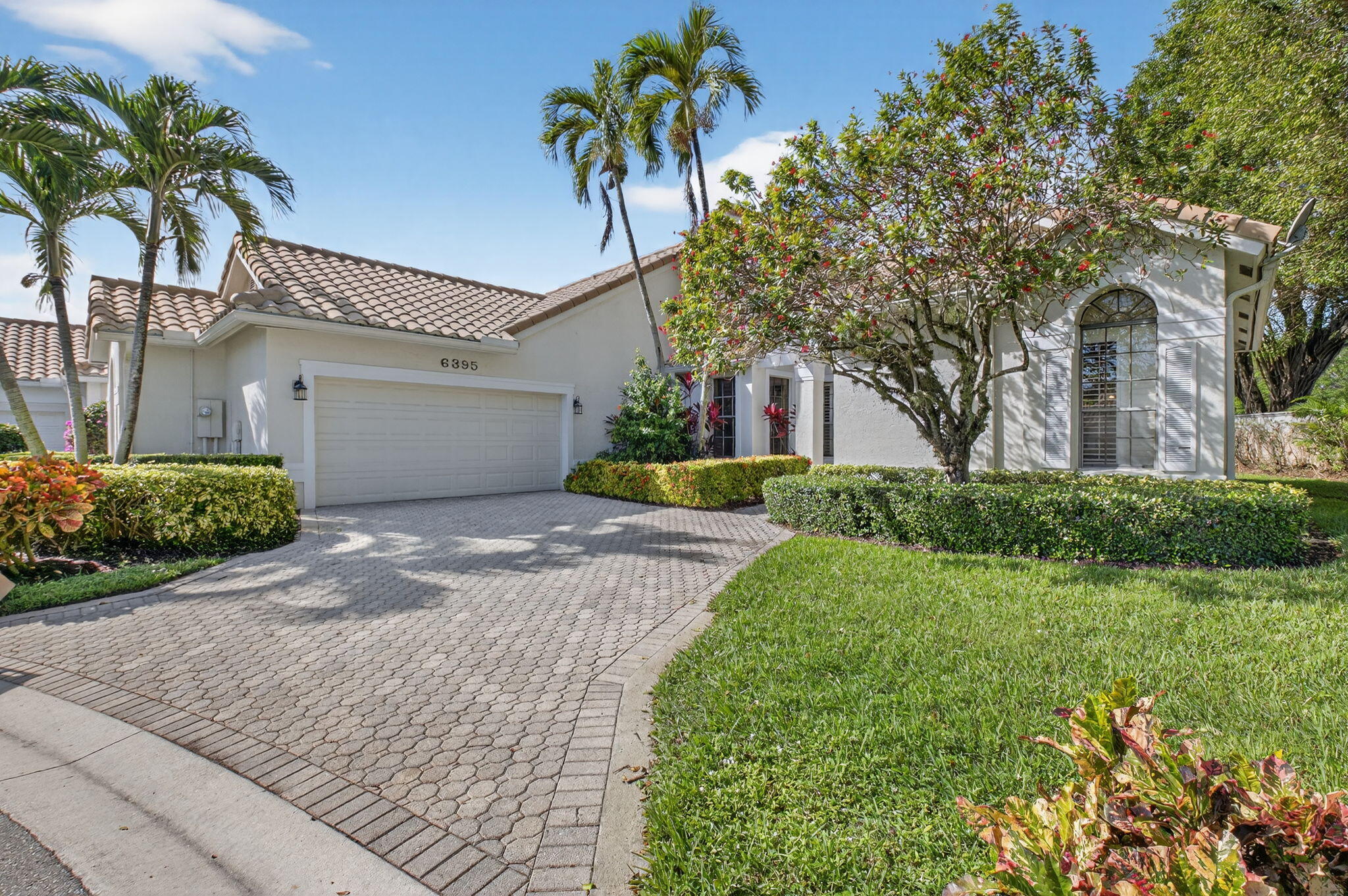 6395 Northwest 24th Avenue Boca Raton, FL 33496 - Photo 1 of 88 a front view of a house with a yard and a garage
