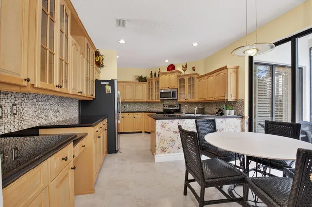 a large bathroom with a double vanity sink a mirror and a bathtub