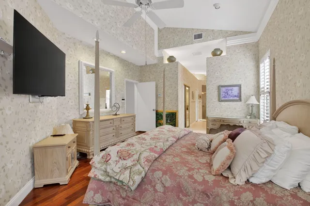 a living room with lots of white furniture and wooden floor