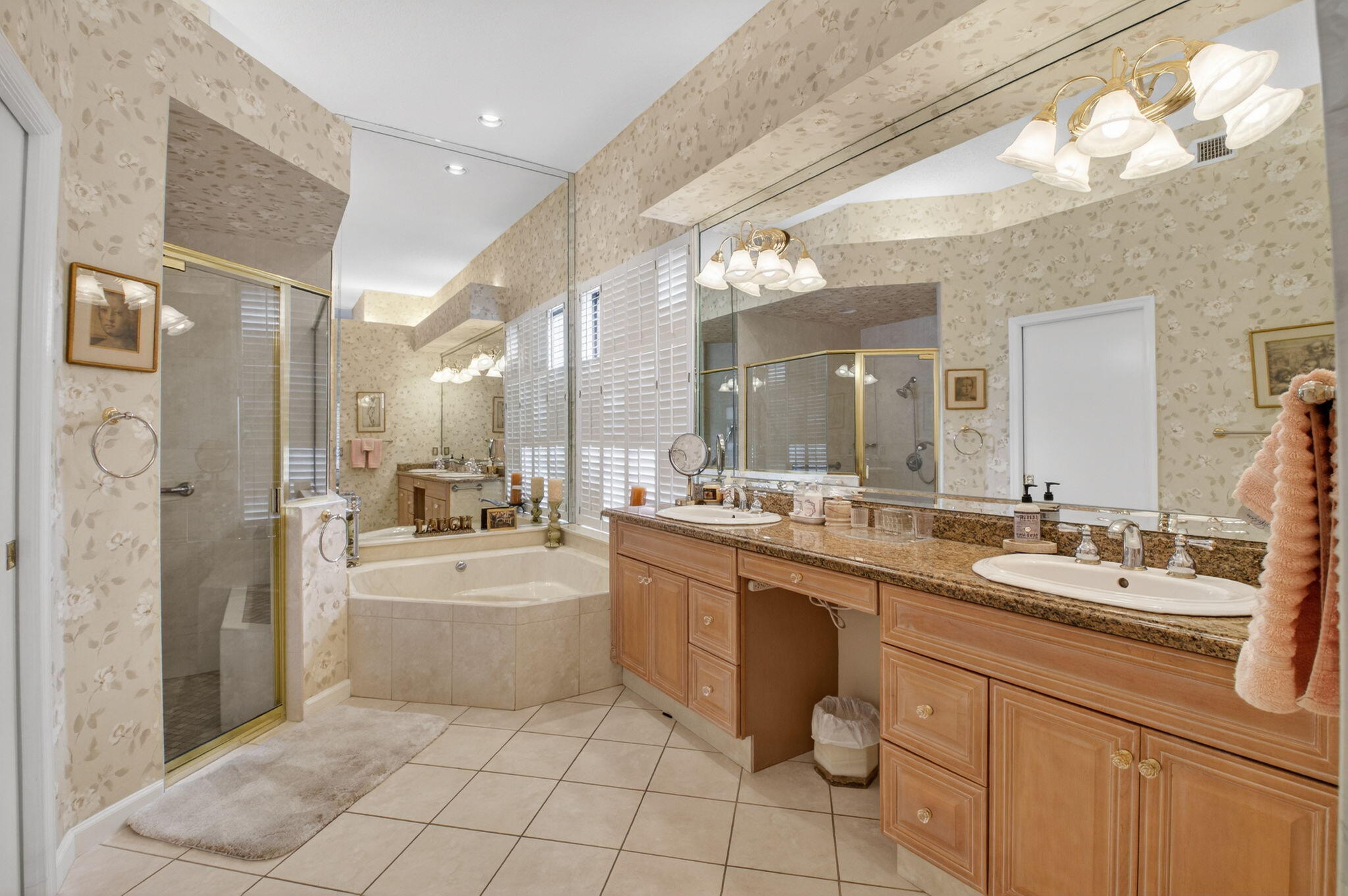 6395 Northwest 24th Avenue Boca Raton, FL 33496 - Photo 28 of 88 a large bathroom with a double vanity sink a mirror and a bathtub