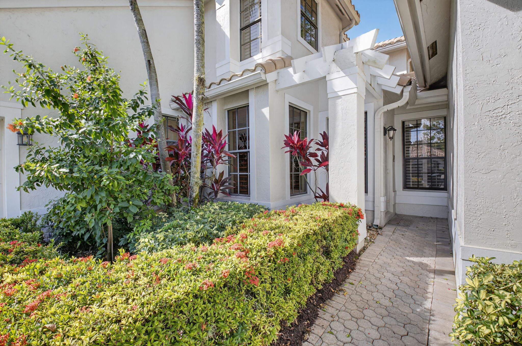 6395 Northwest 24th Avenue Boca Raton, FL 33496 - Photo 3 of 88 a view of a pathway that has bunch of flowers