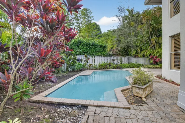 a view of backyard with seating area and trees in the background