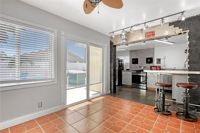 a kitchen with stainless steel appliances kitchen island granite countertop a refrigerator and microwave