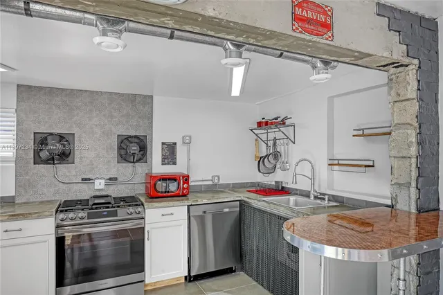 a kitchen with stainless steel appliances granite countertop a stove and a sink