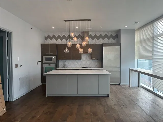 a living room with a chandelier furniture and a potted plant