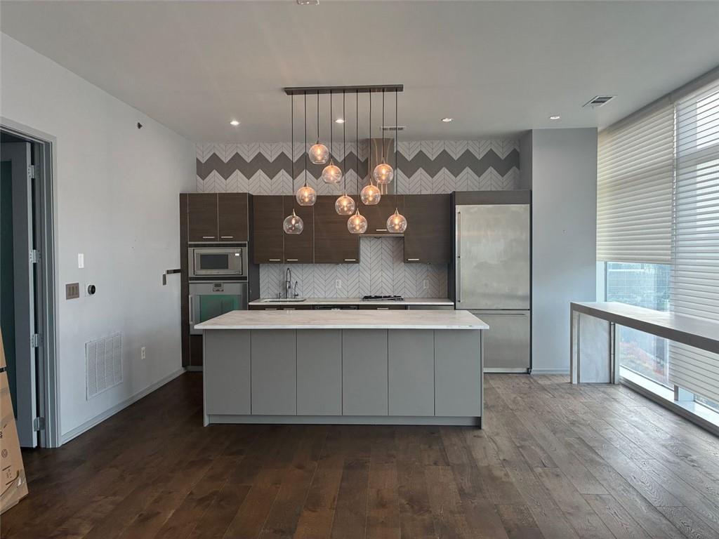 45 Ivan Allen Jr Boulevard Northwest, Unit 1806 Atlanta, GA 30308 - Photo 1 of 13 a living room with a chandelier furniture and a potted plant