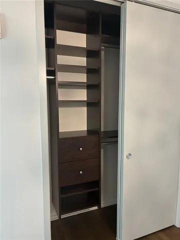 a view of walk in closet with empty racks