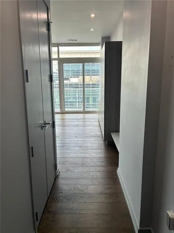 a view of hallway with wooden floor