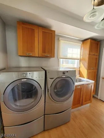 a utility room with sink dryer and washer