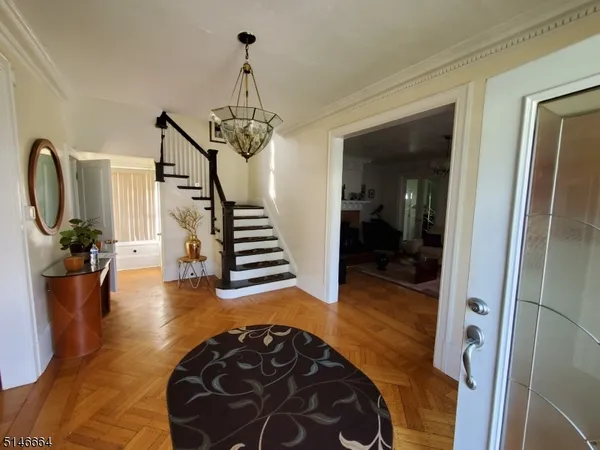a view of a hallway with wooden floor windows and a livingroom