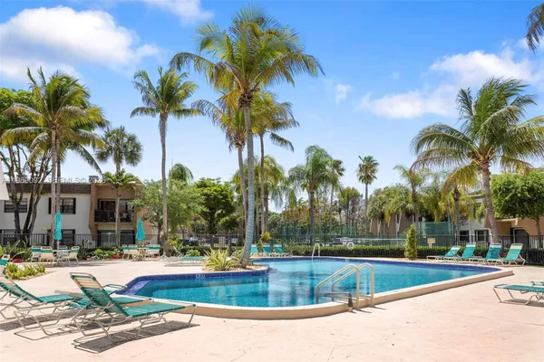 a view of a swimming pool with palm trees