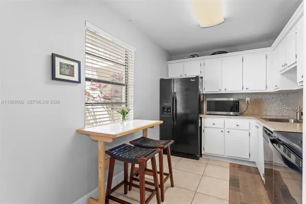 a kitchen with stainless steel appliances a refrigerator sink and cabinets